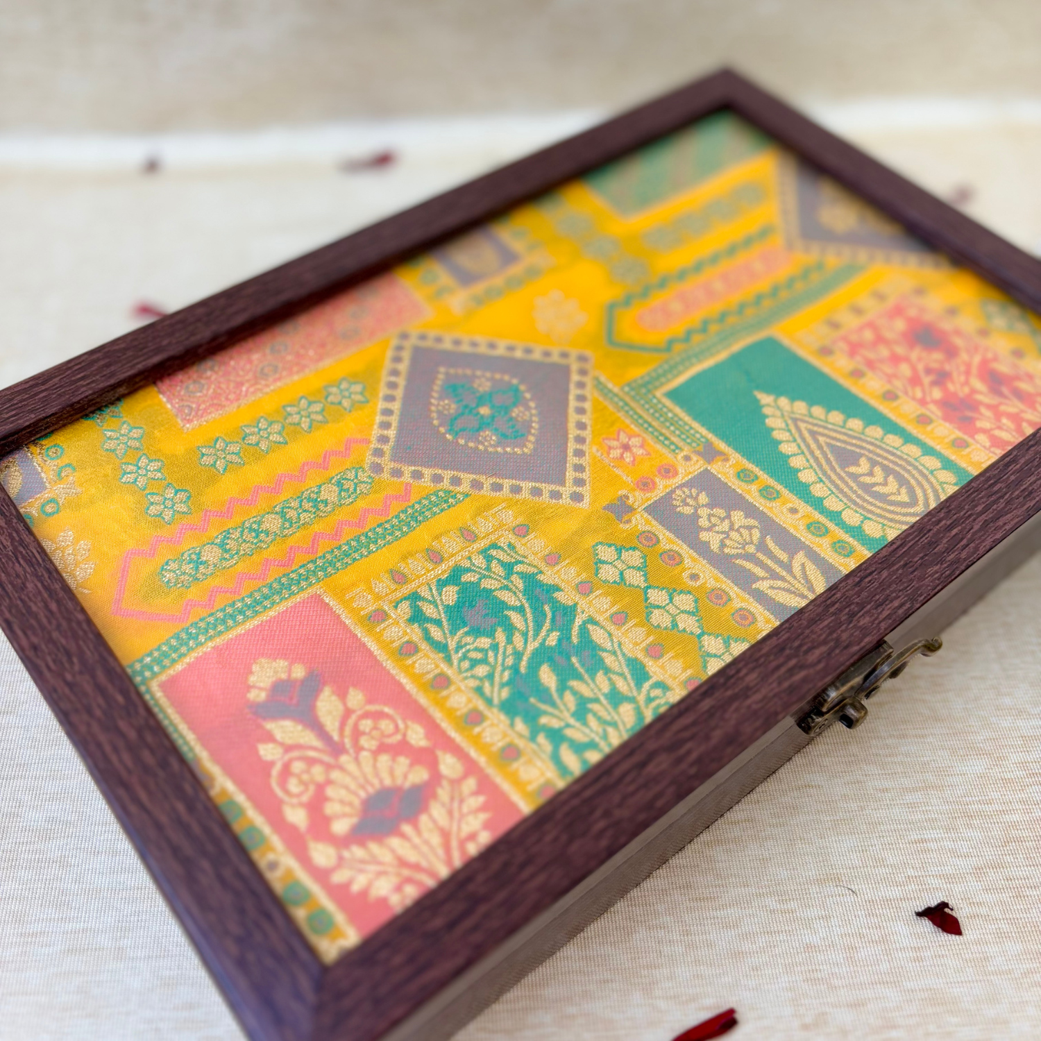 Luxury gifting jewellery box with a vibrant ethnic patchwork pattern in yellow and green.