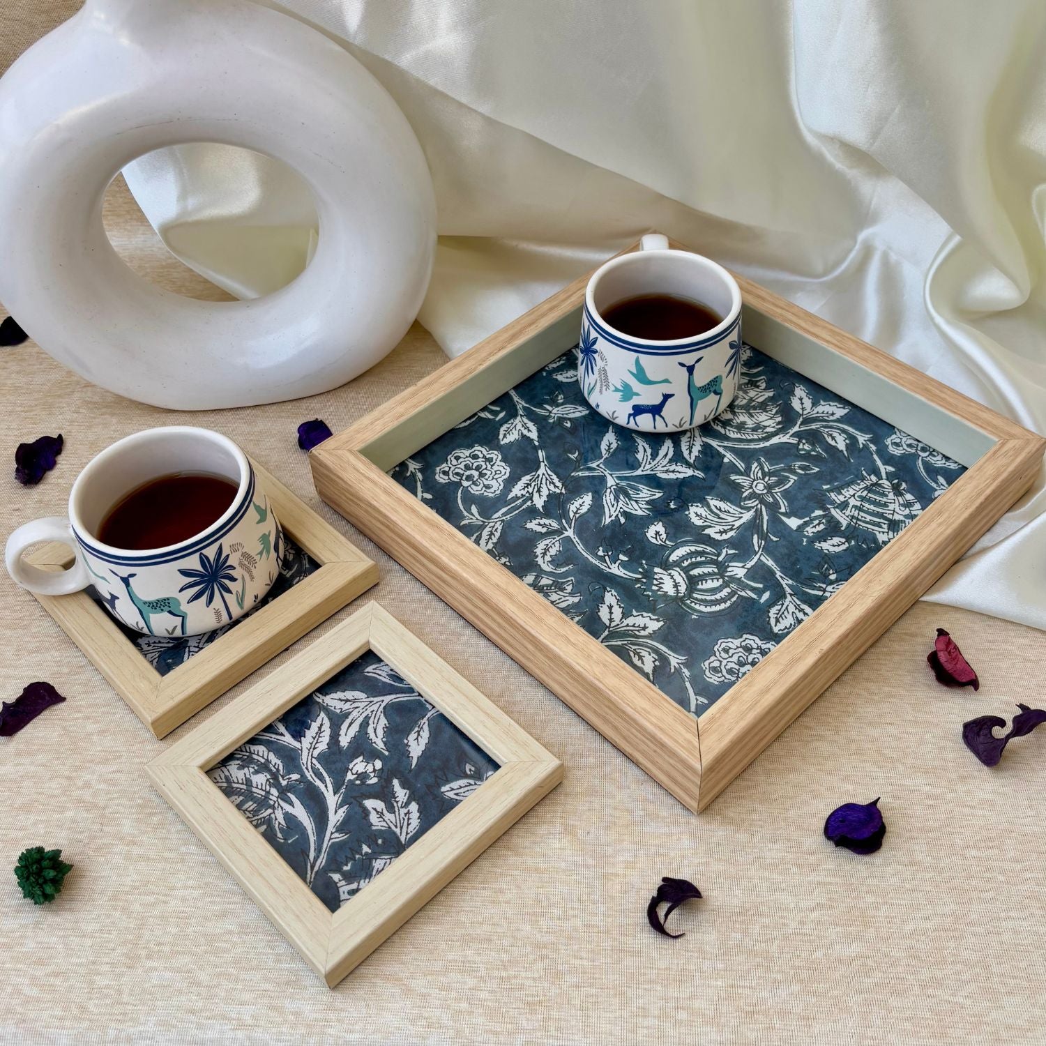 Exquisite indigo print serving tray with matching coasters, crafted for luxurious home décor and sophisticated entertaining.