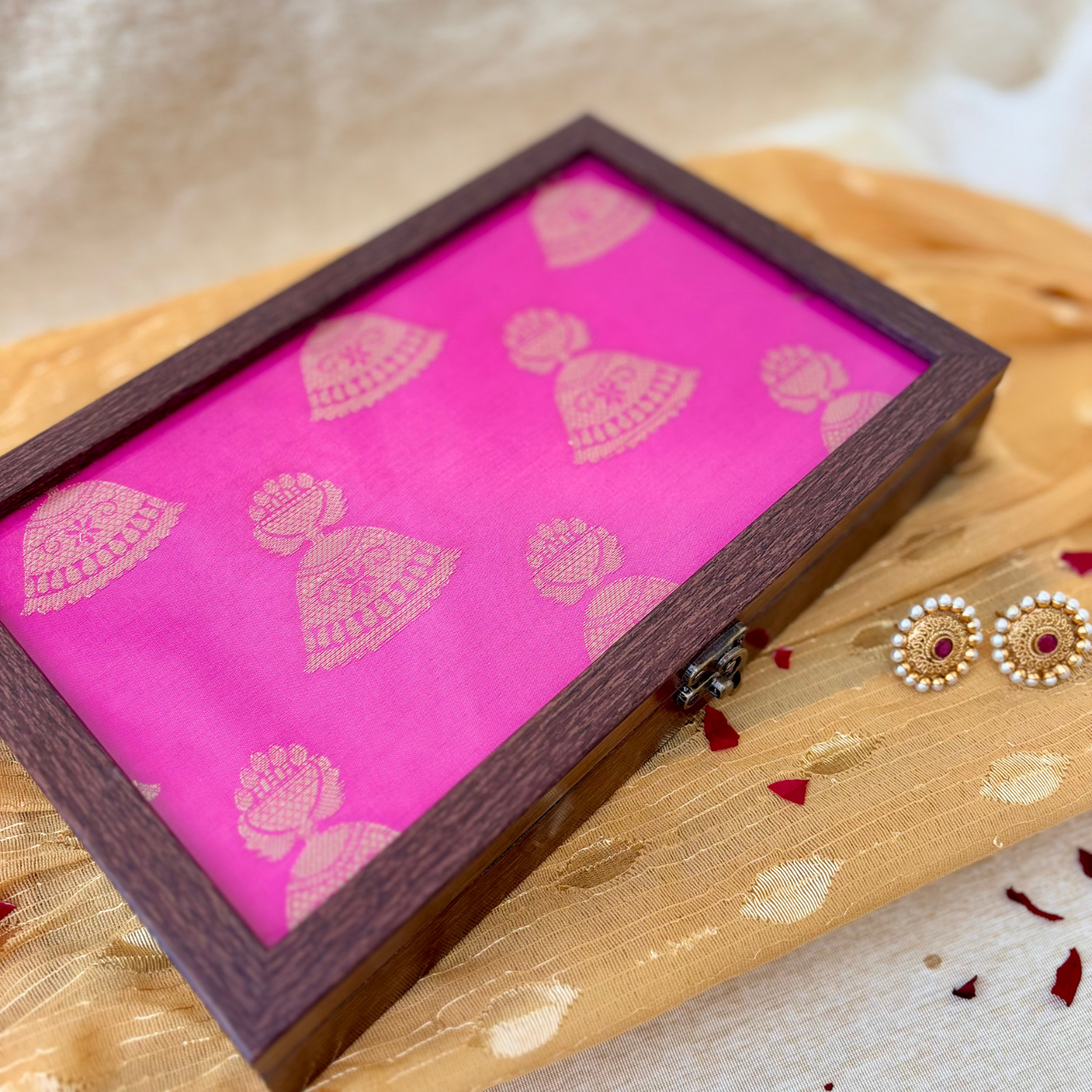 Traditional pink jewellery box with golden jhumka detailing, perfect for gifting or home decoration