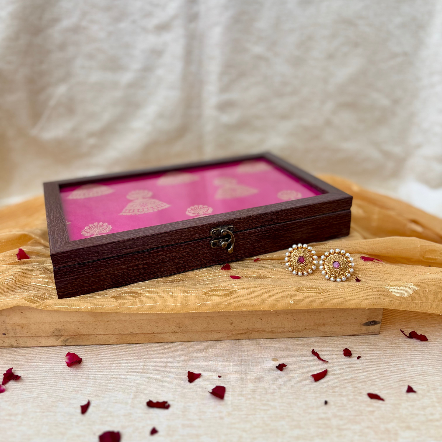 Elegant pink jewelry box with golden jhumka design, perfect for vanity, gifting, and home decor