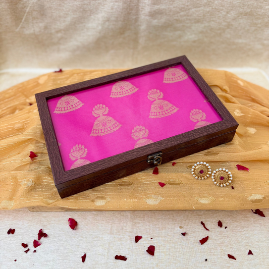 Pink box with golden jhumka motifs, traditional ethnic jewelry storage, and decorative home accessory