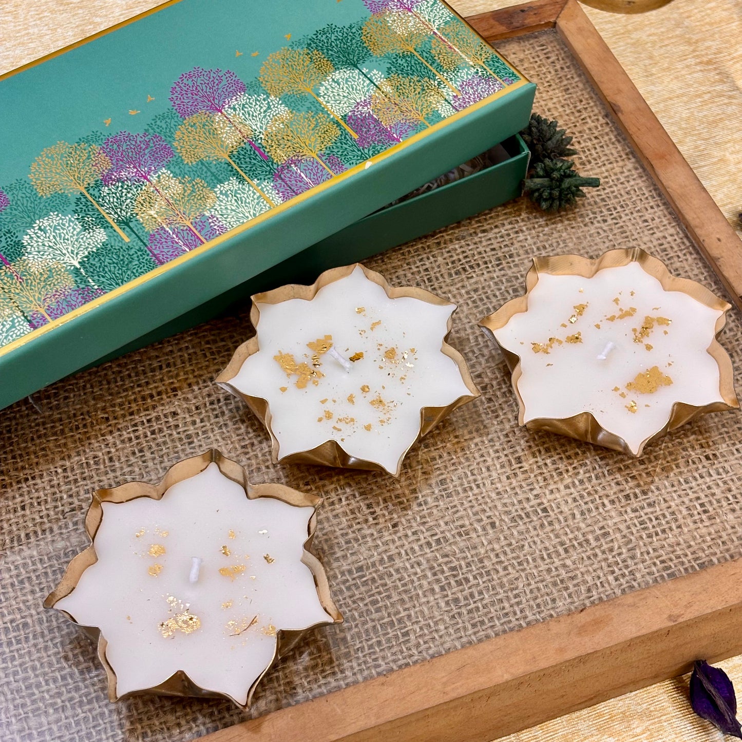 Luxury Indian festive gift set featuring three gold-detailed lotus candles for Diwali parties, corporate events and home décor.
White lotus-shaped vanilla candles with gold accents for elegant Diwali décor, festive tablescapes and party hosting
Kamal luxury candle set featuring white lotus flowers with gold detailing, perfect for festive décor and Diwali event gifting.
