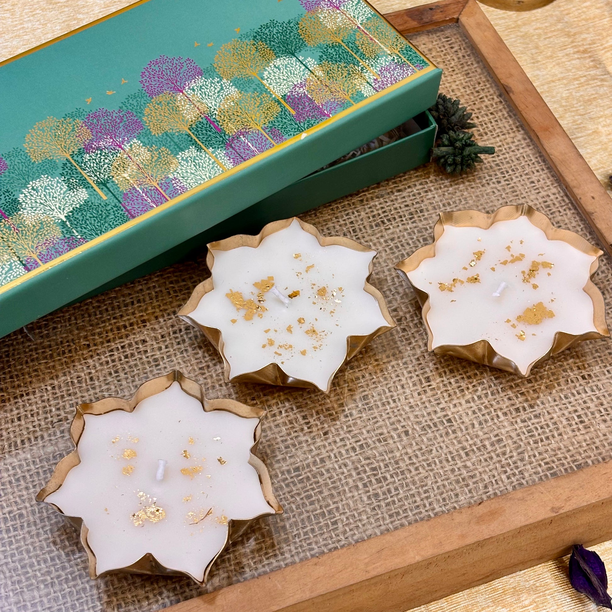 Luxury Indian festive gift set featuring three gold-detailed lotus candles for Diwali parties, corporate events and home décor.
White lotus-shaped vanilla candles with gold accents for elegant Diwali décor, festive tablescapes and party hosting
Kamal luxury candle set featuring white lotus flowers with gold detailing, perfect for festive décor and Diwali event gifting.