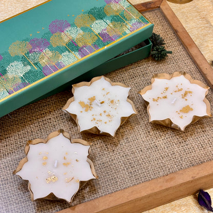 Luxury Indian festive gift set featuring three gold-detailed lotus candles for Diwali parties, corporate events and home décor.
White lotus-shaped vanilla candles with gold accents for elegant Diwali décor, festive tablescapes and party hosting
Kamal luxury candle set featuring white lotus flowers with gold detailing, perfect for festive décor and Diwali event gifting.