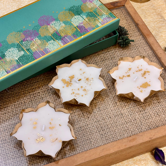 Luxury Indian festive gift set featuring three gold-detailed lotus candles for Diwali parties, corporate events and home décor.
White lotus-shaped vanilla candles with gold accents for elegant Diwali décor, festive tablescapes and party hosting
Kamal luxury candle set featuring white lotus flowers with gold detailing, perfect for festive décor and Diwali event gifting.